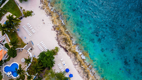 Overhead drone shot of swimmers on a tropical beach in Cozumel  Mexico.