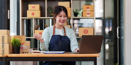 A portrait of Asian woman, e-commerce employee freelance with parcel box for deliver to customer. Online marketing packing box delivery concept.