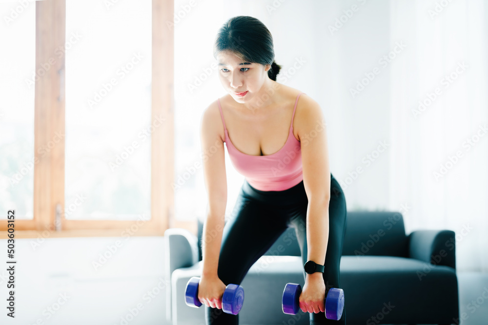 stress relief, , breathing exercises, meditation, portrait of Asian healthy woman lifting weights to strengthen her muscles after work. stress relief, , breathing exercises, meditation, portrait of Asian healthy woman lifting weights to strengthen her muscles after work.