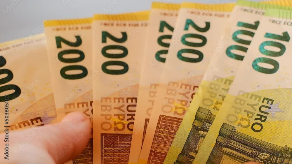 Euro banknotes in hands close-up.Euro currency. Money in hands on blurred gray background.Recalculation of money. High quality 4k footage Euro banknotes in hands close-up.Euro currency. Money in hands on blurred gray background.Recalculation of money. High quality 4k footage