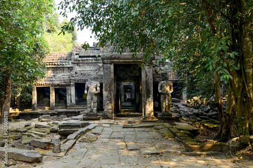 Cambodia, ANGKOR Temple complex, Preah Khan temple (Preah Khan Kampongsvai) in the rainforest, Entrance to the Cambodian temple, columns, headless Statues, Religious structure of the Angkor period photo