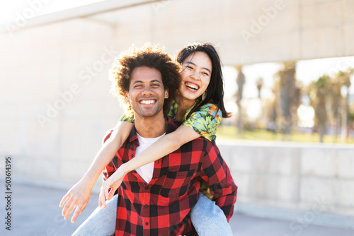 Beautiful young couple in love walking at the city streer. Happy couple having fun outside photo