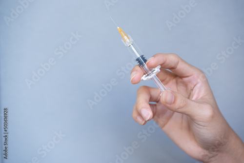 The syringe in the hands of the experts is ready to use.