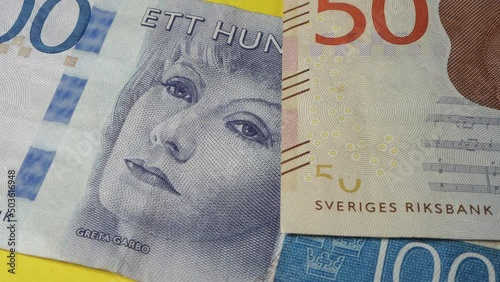 the effigy of some famous Swedish people on Swedish kronor banknotes	 photo