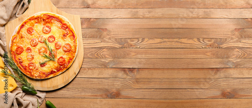 Tasty baked pizza on wooden background with space for text