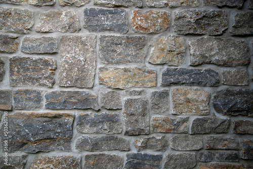 Close-up shot of a vintage stonework wall background. photo