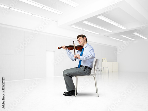 young businessman playing violin
