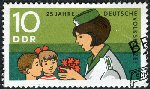 GERMANY - CIRCA 1970: Postage stamp from Germany showing a policewoman with children