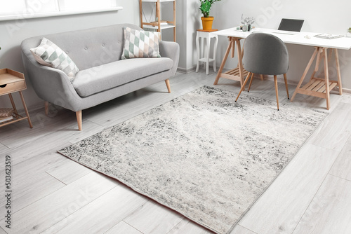 Carta da parati Interior of living room with comfortable sofa, workplace and soft carpet