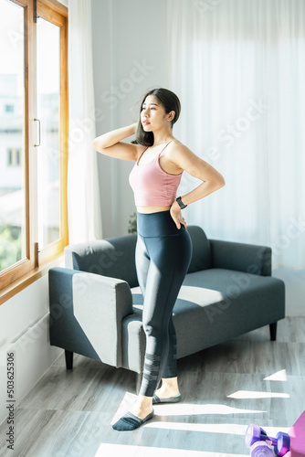 stress relief, muscle relaxation, breathing exercises, exercise, meditation, portrait of Young Asian woman relaxing her body from office work by practicing yoga by watching online tutorials.