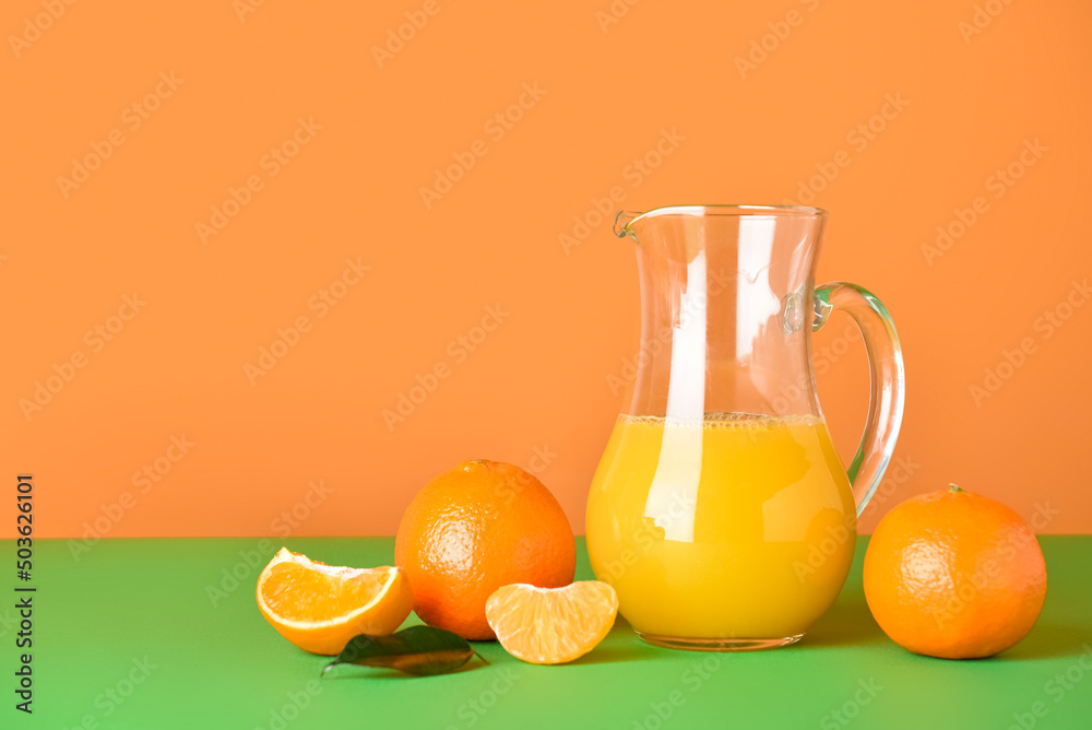 Jug of fresh tangerine juice on color background Jug of fresh tangerine juice on color background