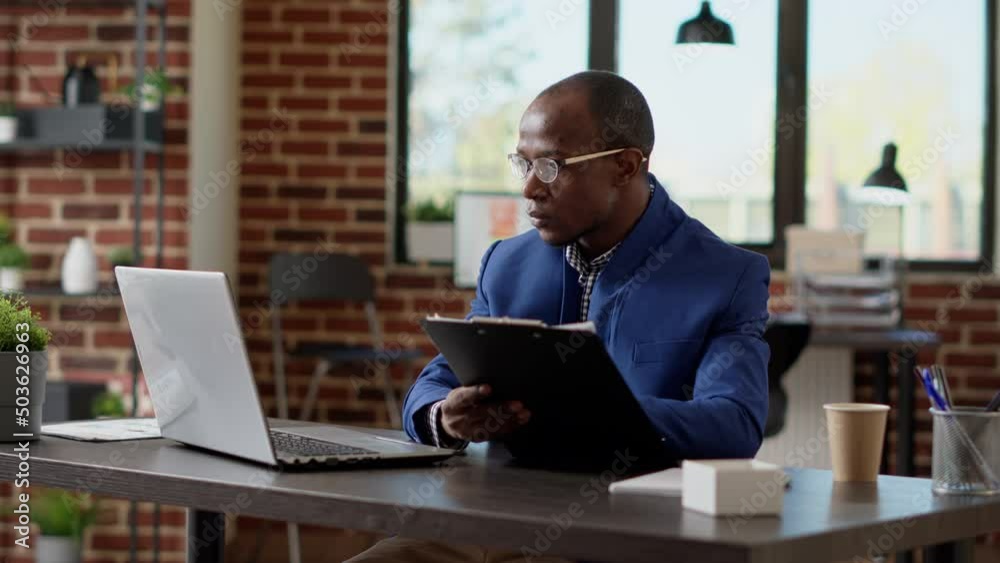 Project manager analyzing statistics plan with application report on laptop at office desk. Company employee working on computer to create business strategy on website browser.