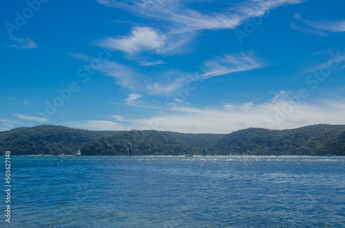 Blue sky and ocean water with mountain view at Palm beach NSW. © arliftatoz2205