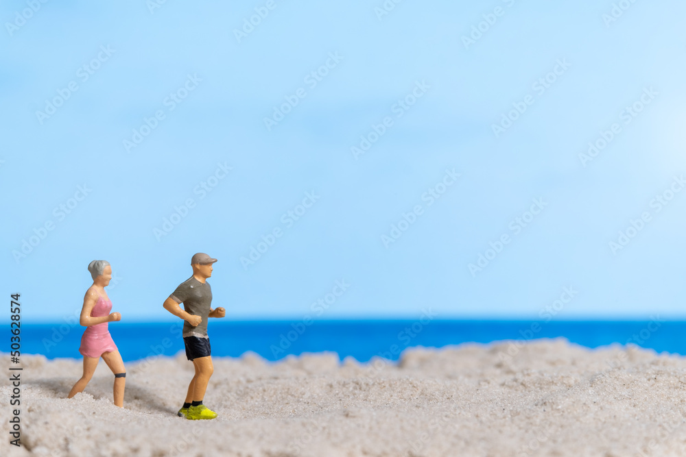 Miniature people Couple running together on The beach Miniature people Couple running together on The beach