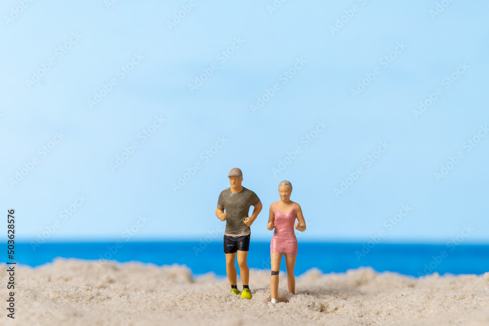 Miniature people Couple running together on The beach Miniature people Couple running together on The beach