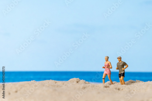 Miniature people Couple running together on The beach