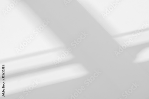 Gray shadow and light blur abstract background on white wall  from window.  Architecture dark shadows indoor