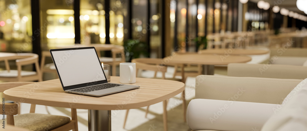 Comfortable restaurant or coffee shop seating area interior design with laptop mockup Comfortable restaurant or coffee shop seating area interior design with laptop mockup