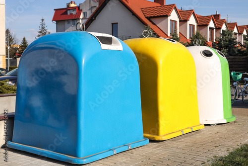 Bright colorful recycling bins outdoors on sunny day