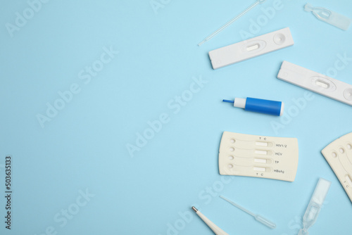 Disposable express hepatitis test kit on light blue background, flat lay. Space for text