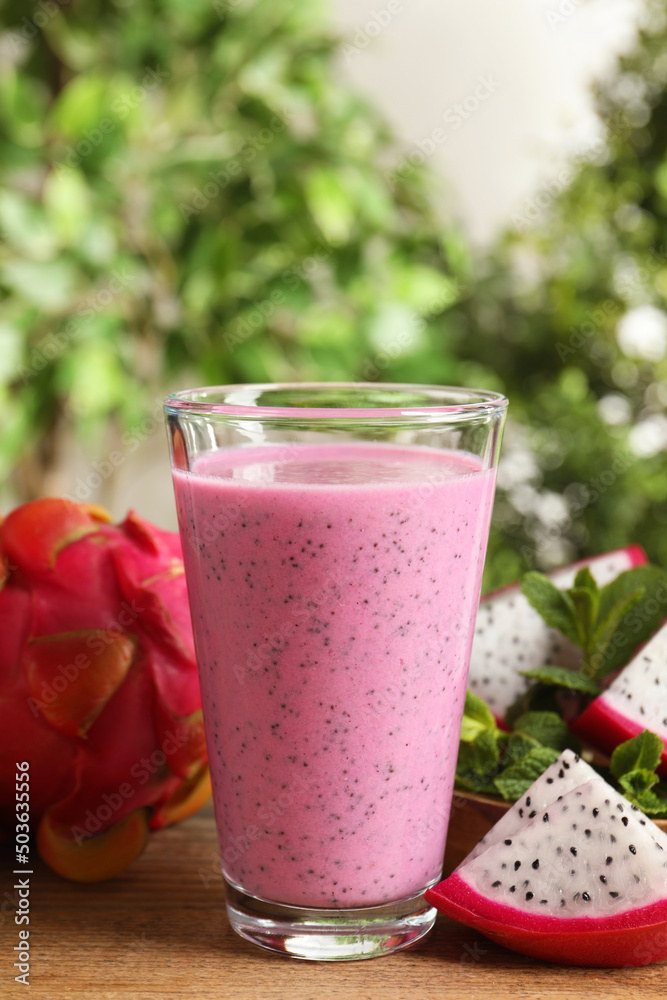 Delicious pitahaya smoothie and fresh fruits on wooden table Delicious pitahaya smoothie and fresh fruits on wooden table