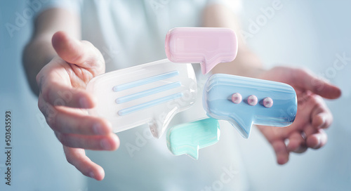 Businessman holding digital speech bubbles talk icons. Minimal conversation or social media messages floating between man hands. 3D rendering