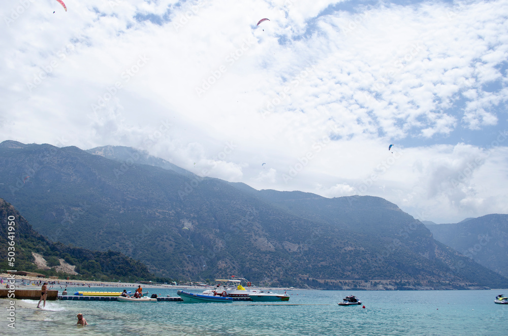 Oludeniz Beach, which is famous for its sandy beach and blue sea, is where paragliders jumping from Babadag land.