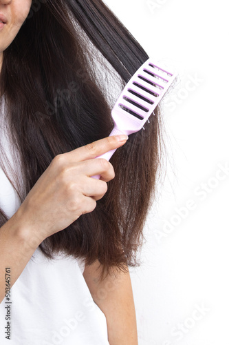 A young woman with long hair and a pipette in her hand. Hair treatment and care