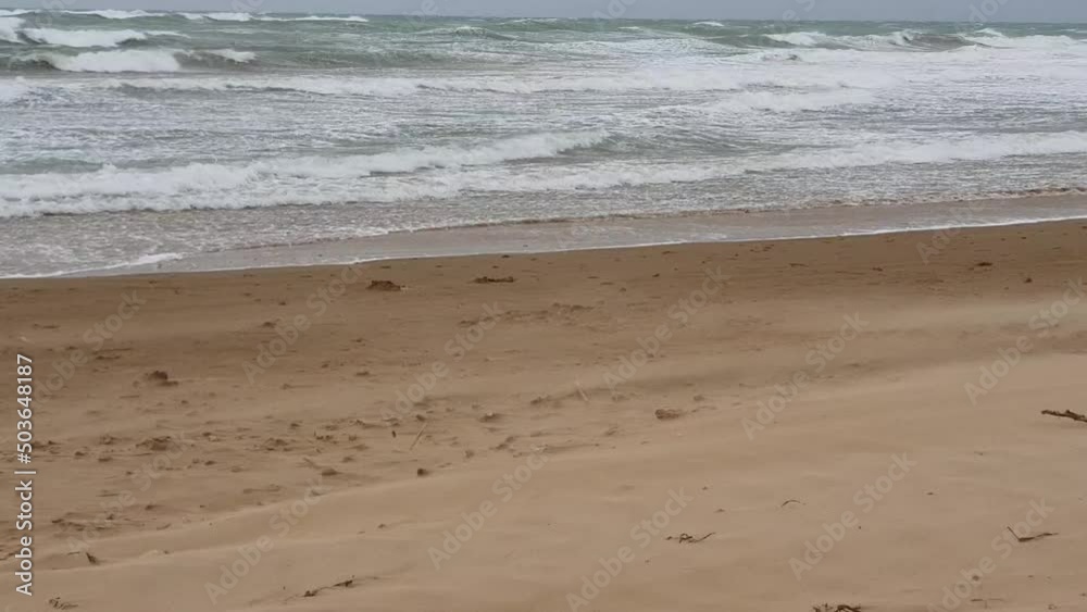 sand flying at the beach because of strong wind, in puzziteddu on the island of sicily in italy sand flying at the beach because of strong wind, in puzziteddu on the island of sicily in italy
