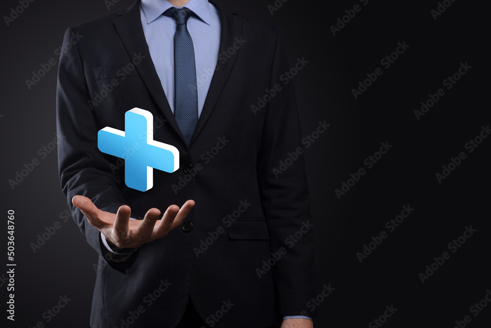 Businessman hold 3D plus icon, man hold in hand offer positive thing such as profit, benefits, development, CSR represented by plus sign.The hand shows the plus sign Businessman hold 3D plus icon, man hold in hand offer positive thing such as profit, benefits, development, CSR represented by plus sign.The hand shows the plus sign