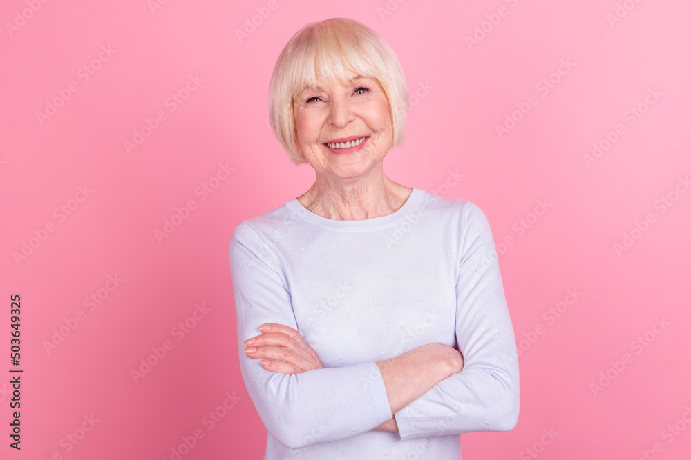 Photo of mature pretty woman crossed hands confident clever marketer isolated over pink color background Photo of mature pretty woman crossed hands confident clever marketer isolated over pink color background