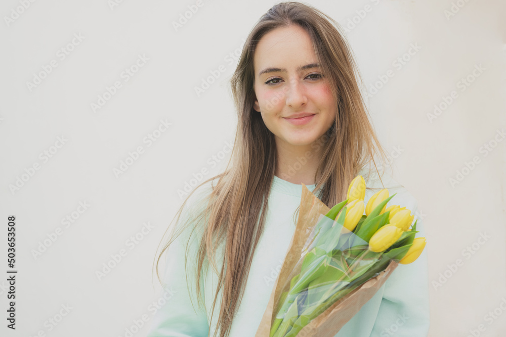 Beautiful young girl with a bouquet of flowers outdoors Beautiful young girl with a bouquet of flowers outdoors