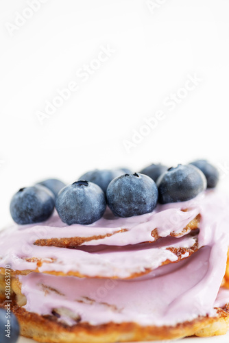 pancakes with blueberries and yogurt on white background