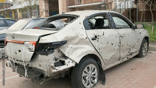 Irpin, Ukraine, April 2022. Damaged car after being hit by shell fragments. Consequences of the war with Russia.