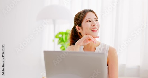 asian women uses laptop leisurly photo