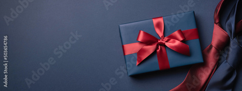 Foto Banner with blue gift box and neckties on dark blue background
