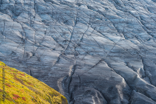 Massive crevassed glacier background texture over the hillside