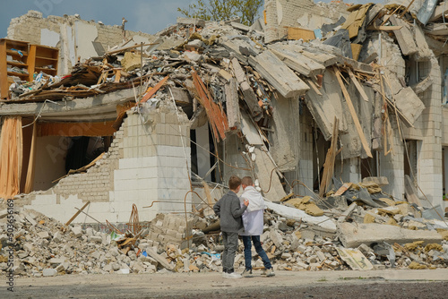 Boys at destroyed school in the Ukrainian city. Russian aggression concept
