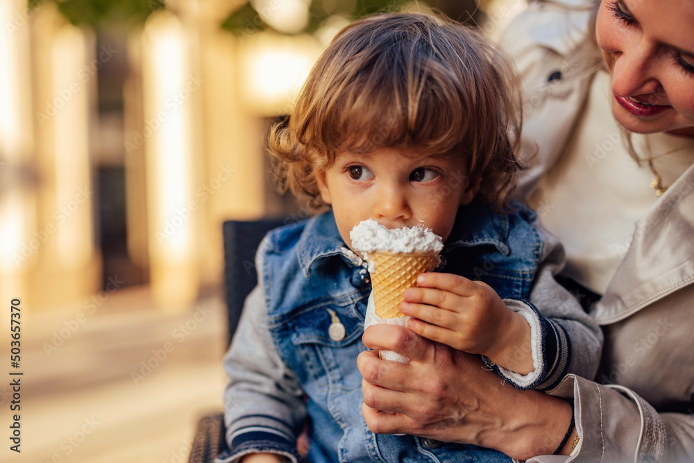 A close-up of a toddler, eating ice cream, gets dirty around his mouth. A close-up of a toddler, eating ice cream, gets dirty around his mouth.
