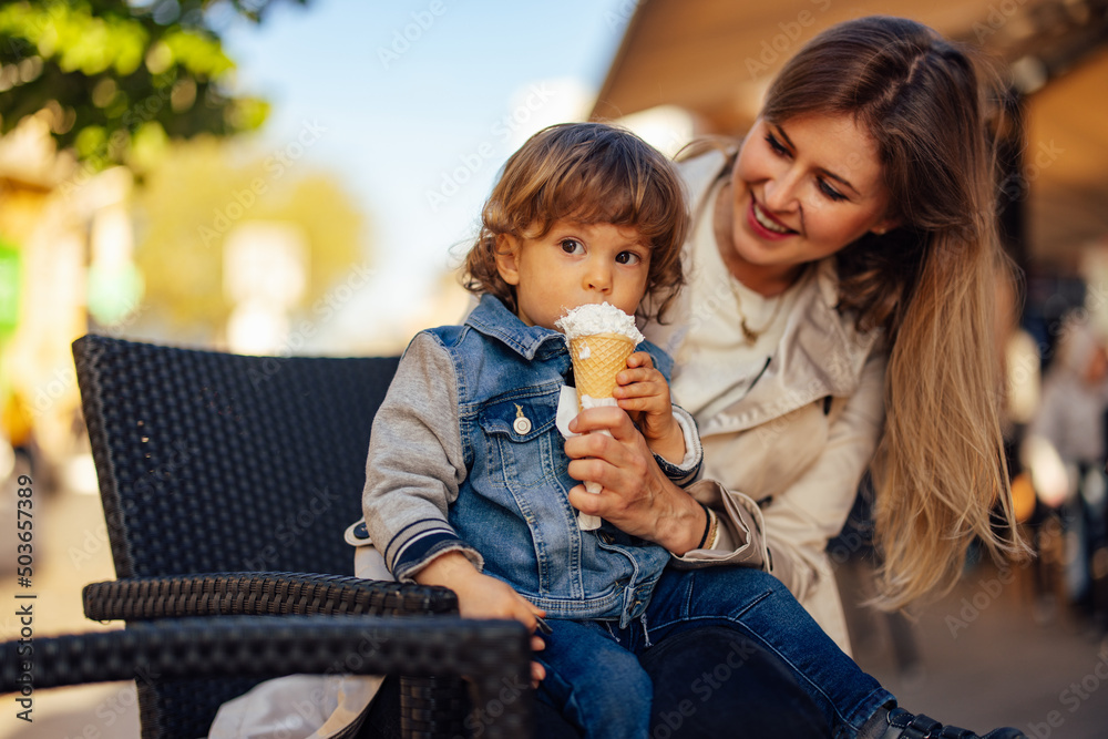 Single parent enjoying with her toddler, eating ice cream. Single parent enjoying with her toddler, eating ice cream.