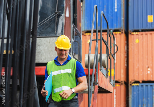 Engineer in hardhat on stacker lifting container control loading containers box, Dock worker man with clipboard checklist on forklift truck lifting container at cargo