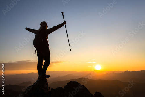 Silhouette of a woman standing on a mountain concept of leadership, success, hiking.