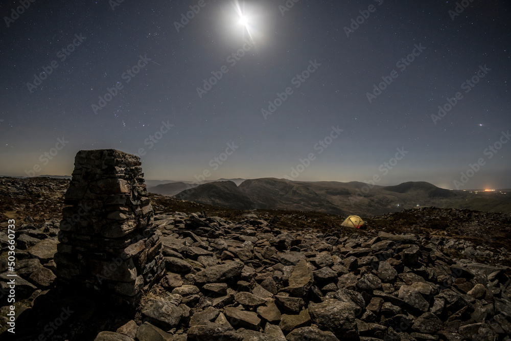 A wild camping tent on a mountain summit at night in North Wales A wild camping tent on a mountain summit at night in North Wales