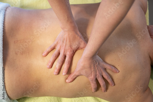 Close up of a physiotherapist doing back massage on a patient © Eva