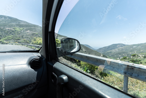 View of the mountains through the car window. road trip, driving on mountain road.