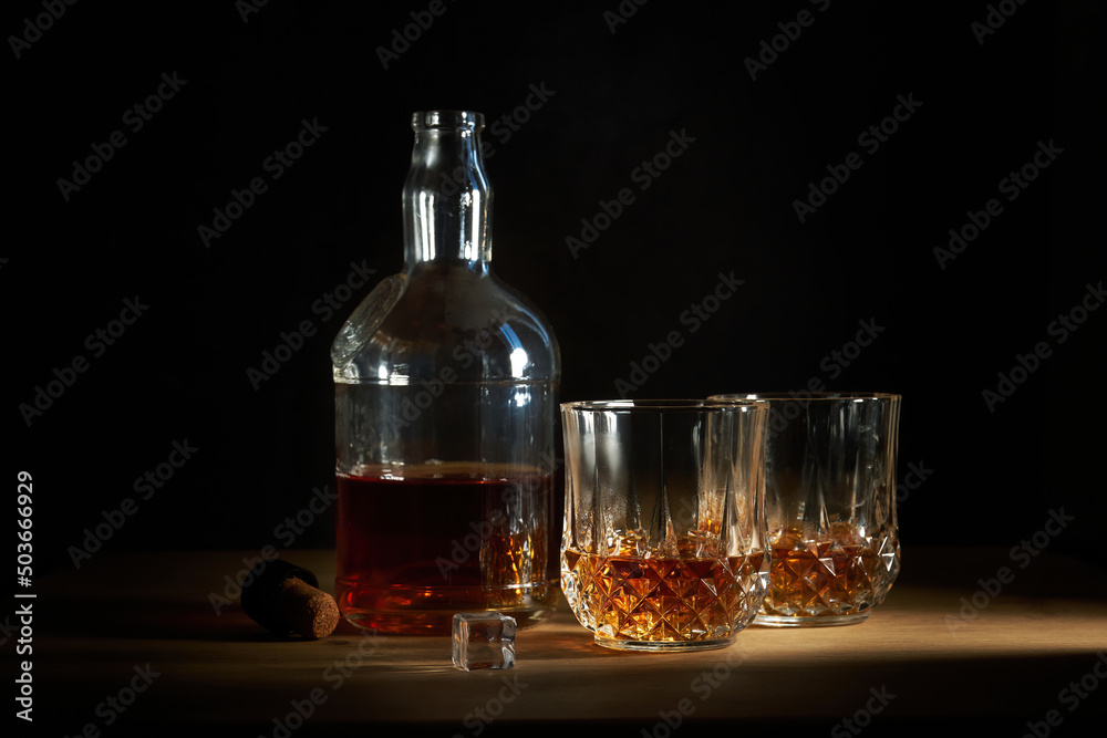 a bottle of cognac with two glasses a bottle of cognac with two glasses