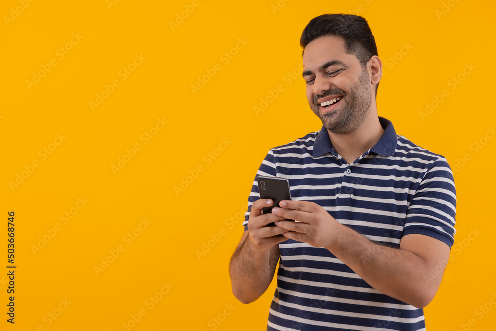 Portrait of happy young man having fun while using Smartphone Portrait of happy young man having fun while using Smartphone