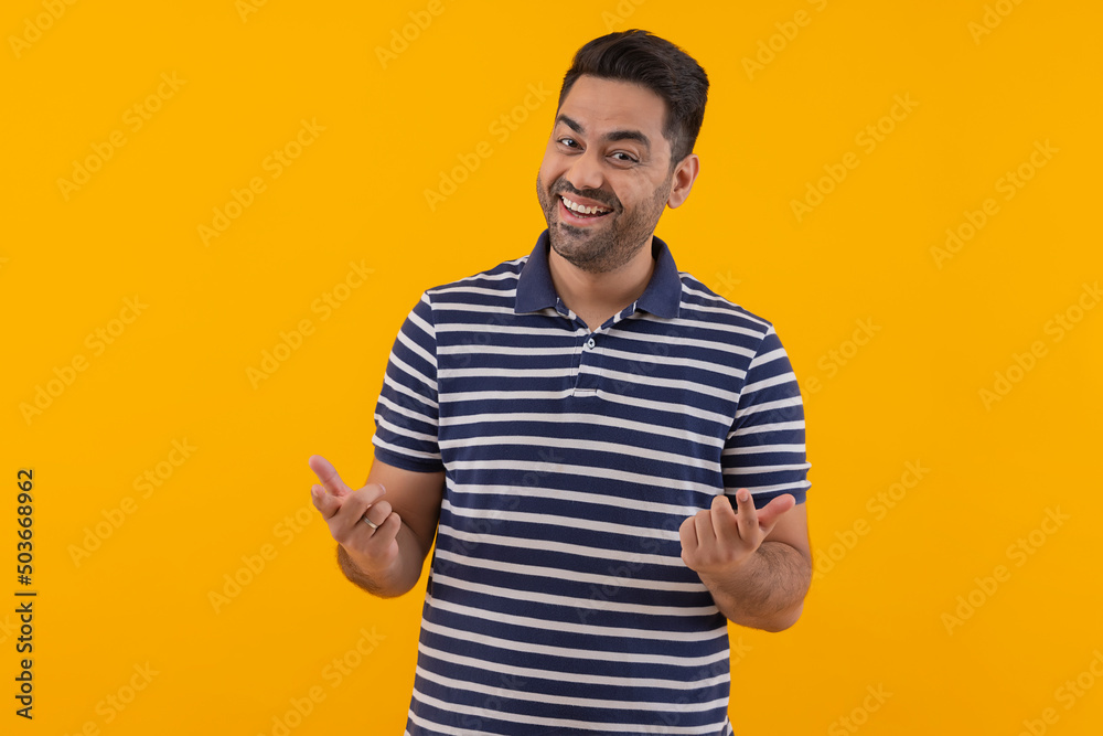 Portrait of happy young man posing in front of camera against yellow background Portrait of happy young man posing in front of camera against yellow background
