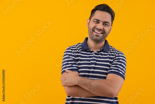 Portrait of happy young man with folded hands