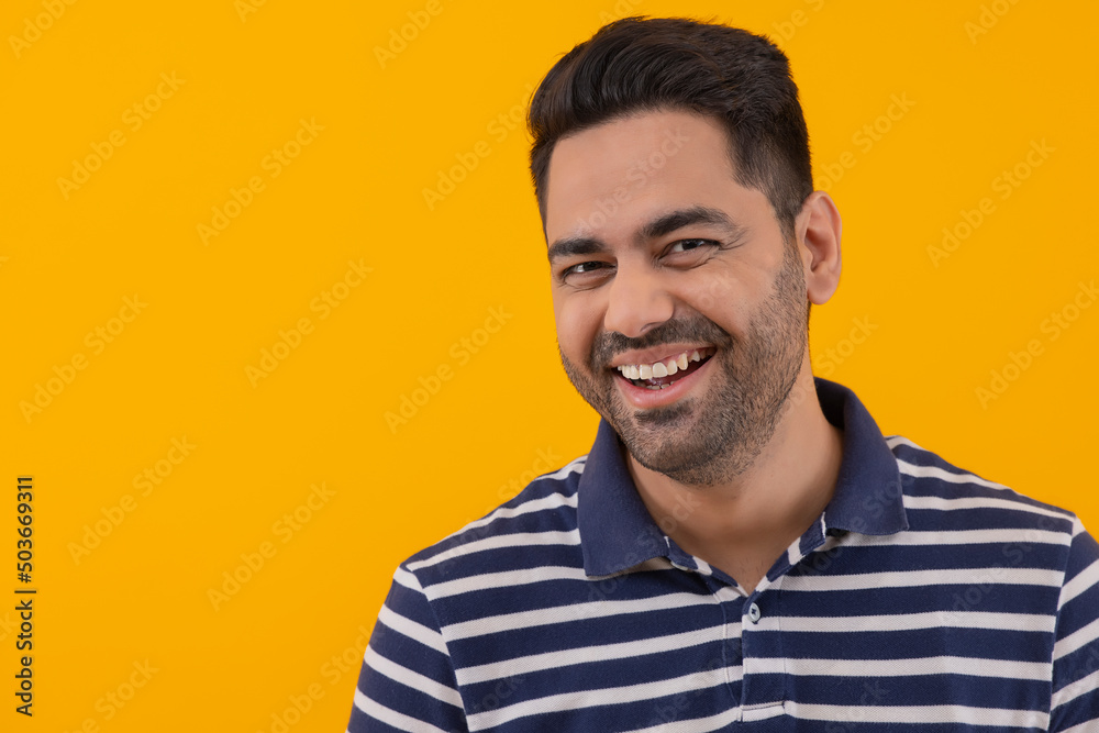 Portrait of smiling young man against yellow background Portrait of smiling young man against yellow background